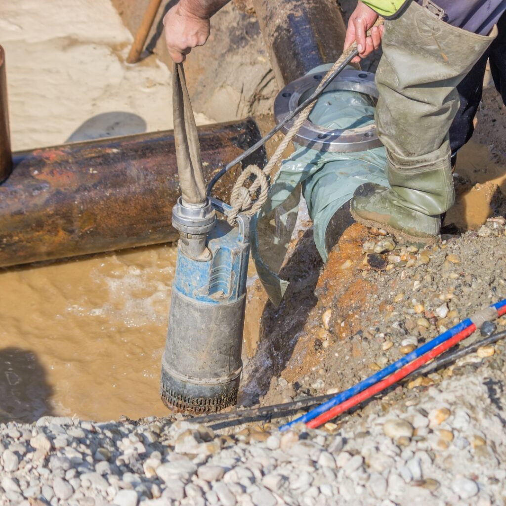 Worker installing Submersible Pump