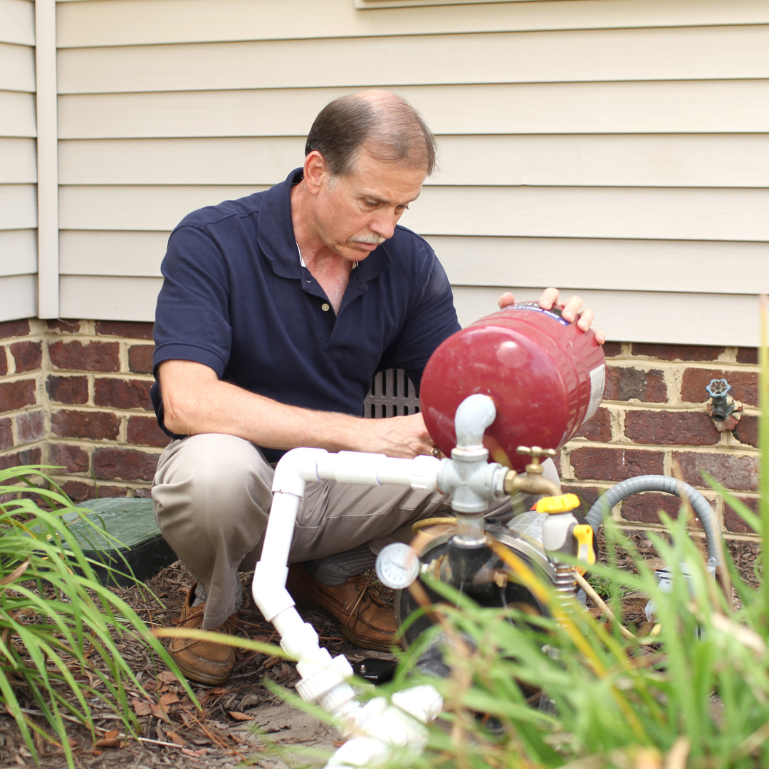 A homeowner working on their well water pump